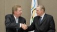 United States Olympic Committee chairman Larry Probst, left, and Olympic Committee President Jacques Rogge shake hands after signing an agreement between the IOC and the USOC at the SportAccord conference in Quebec City,  May 24, 2012 (AP).