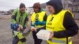 Ivar Hjelmen (L), 4, and his mother Kari (2nd L) give coffee and bread to striking workers standing on May 24, 2012 outside Kroken kindergarden in the northern Norwegian town of Tromsoe.