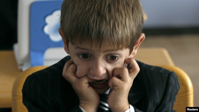 A first grader attends his first English language lesson at a local school in Tbilisi, September 15, 2010.