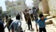 This image made from amateur videoshows  Syrians running from gun shots in Khan Sheikhoun, Idlib, Syria, May 15, 2012.