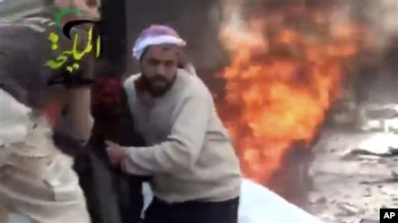 This video provided by Shaam News Network, which has been authenticated, shows a wounded man being pulled from the site of a Syrian government airstrike on a gas station in the eastern Damascus suburb of Mleiha, Syria, Jan. 2, 2013.