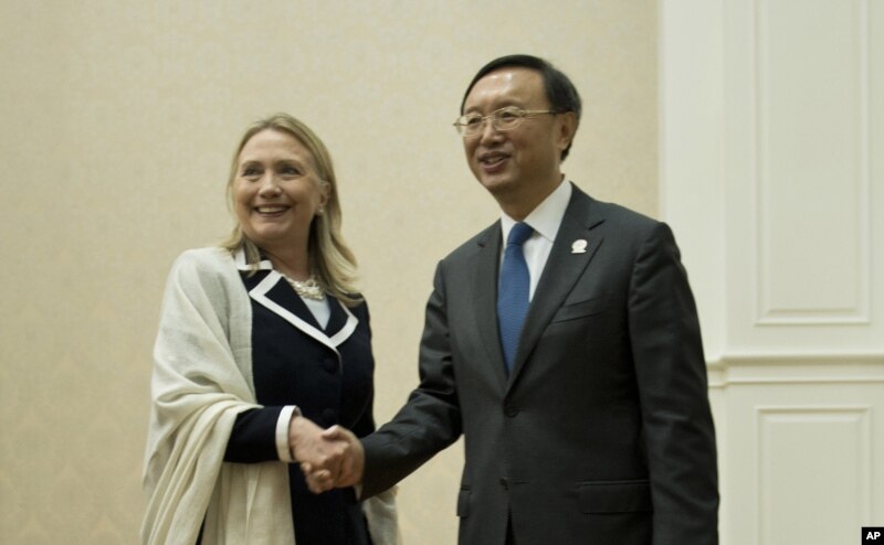 U.S. Secretary of State Hillary Rodham Clinton, left, and Chinese Foreign Minister Yang Jiechi pose for photos before their meeting on the sideline of the ASEAN regional forum in Phnom Penh, July 12, 2012.