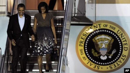 President Barack Obama and first lady Michelle Obama arrive at Chicago O'Hare International Airport to attend the NATO Summit, Saturday, May 19, 2012 in Chicago.