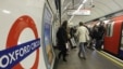 People board an underground 'Tube' train at Oxford Circus underground station in London.