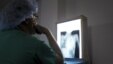A doctor from an international cardiac mission examines the x-ray of a patient's heart in the Degand Clinic in Port-au-Prince, April 15, 2012. 