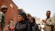 Voters check the registration lists on the second day of balloting. (Y. Weeks/VOA)
