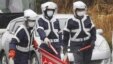 Police officers wearing face masks inspect vehicles at the entrance of a 20km no-entry zone, on the outskirts of Hirono town, Fukushima prefecture, Japan, March  2012. (file photo)