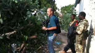 VOA's Peter Heinlein investigates wreckage from the "Black Hawk Down" incident near Mogadishu, Somalia, Aug. 13, 2011. (VOA Photo/G. Joselow)