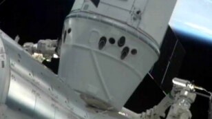 The Canadarm 2 on the International Space Station (ISS) holds the SpaceX Dragon capsule in place after docking/'berthing' with the ISS, May 25, 2012.