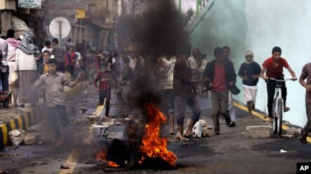 Protesters run as police, unseen, open fire into the air near the U.S. Embassy during a protest about a film ridiculing Islam's Prophet Muhammad, in Sanaa, Yemen, Thursday, Sept. 13, 2012. 